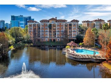 Resort-style community with pool, lake, and fountain at 12556 Floridays Resort Dr # 207-A, Orlando, FL 32821