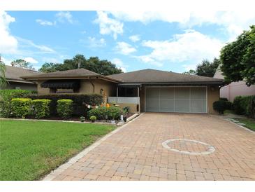 Single story home with large driveway and lush landscaping at 571 Saint Andrews Rd, Winter Haven, FL 33884