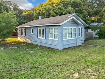 Charming blue house with large windows and yard at 1628 S Grove St, Eustis, FL 32726