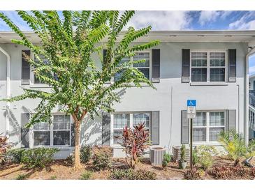 Light blue building exterior with gray shutters and landscaping at 4878 Conway Rd # 91, Orlando, FL 32812