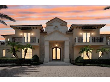 Stunning two-story home with a grand entrance and meticulously landscaped grounds at 5174 Vardon Dr, Windermere, FL 34786