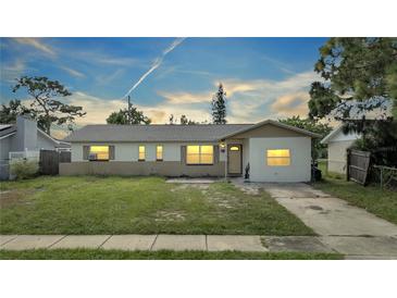 House exterior showcasing a well-maintained lawn and driveway at 8116 Powell Dr, Orlando, FL 32822