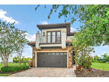 Stunning two-story home with a beautiful balcony and garage at 735 Golden Bear Dr, Reunion, FL 34747