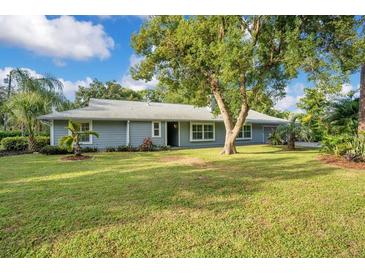Ranch style home with lush lawn and mature trees at 235 Oakdale St, Windermere, FL 34786