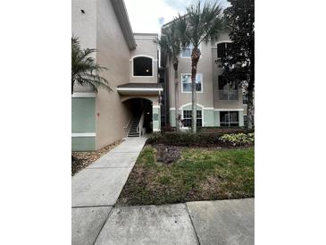 Exterior view of a condo building with palm trees at 4817 Cypress Woods Dr # 5107, Orlando, FL 32811