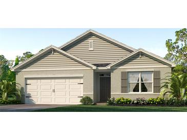 Single-story home with beige siding, white garage door, and landscaping at 1552 Lakeside Dr, Deland, FL 32720