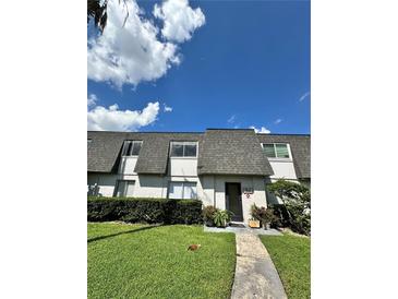 Condo building exterior with grassy lawn at 1944 Conway Rd # 6, Orlando, FL 32812