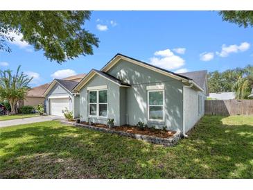 Charming one-story house with a well-manicured lawn at 1451 Twin Rivers Blvd, Oviedo, FL 32766