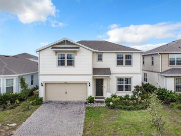 Two story house with a two car garage and landscaped yard at 5616 Arborvista Dr, St Cloud, FL 34771
