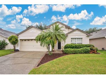 House exterior, showcasing a well-maintained lawn and neutral colors at 2168 Hammock Moss Dr, Orlando, FL 32820