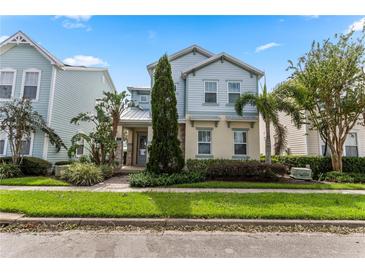 Two-story home with light blue siding and stone accents at 1407 Fairview Cir, Reunion, FL 34747