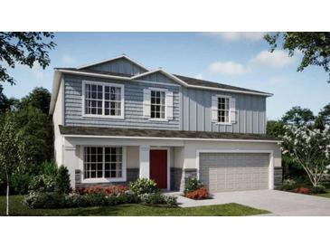 Two-story house with gray siding and red door at 2949 Sunset Dr, New Smyrna Beach, FL 32168