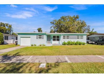 Charming light blue house with well-maintained lawn and driveway at 2811 Vine St, Orlando, FL 32806