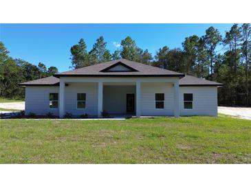Charming one-story home with covered porch at 13356 Sw 64Th Street Rd, Ocala, FL 34482