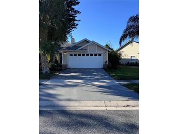 House exterior featuring a two-car garage at 2939 Falling Tree Cir, Orlando, FL 32837