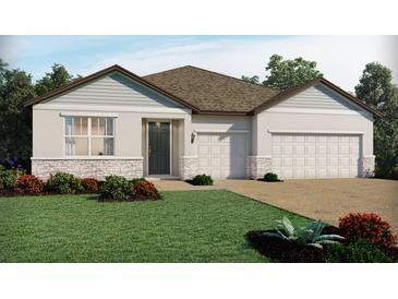 One-story home with two-car garage and stone accents at 2130 Divot Dr, Daytona Beach, FL 32124