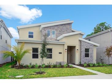 Two-story home with modern design, stone accents, and palm trees at 4625 Target Blvd, Kissimmee, FL 34746