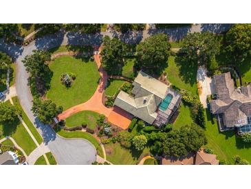 Bird's eye view of house, pool, and landscaped yard at 2128 Lake Crescent Ct, Windermere, FL 34786