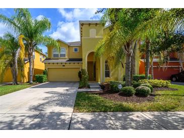 Two-story home with attached garage and lush landscaping at 221 Las Fuentes Dr, Kissimmee, FL 34746