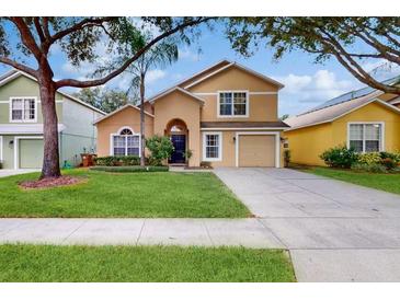 Two story house with front yard and driveway at 17833 Woodcrest Way, Clermont, FL 34714