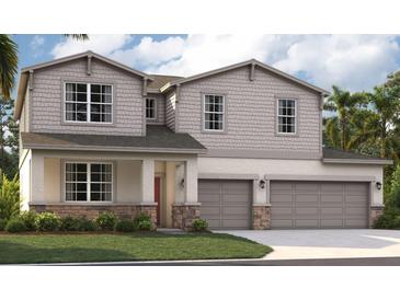 Two-story home with stone accents and two-car garage at 12783 Trovita Dr, Grand Island, FL 32735