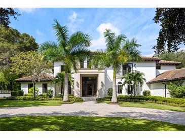 Two story luxury home with palm trees and circular driveway at 5121 Latrobe Dr, Windermere, FL 34786