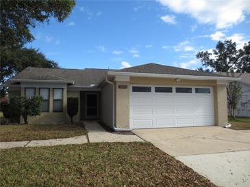 One-story house with attached garage and well-maintained lawn at 5595 Deer Creek Dr, Orlando, FL 32821