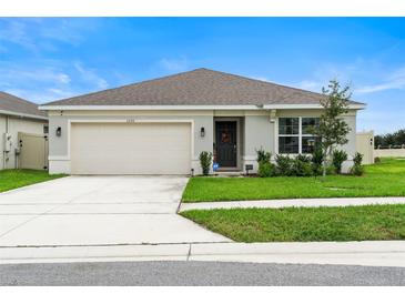 Newly built home with a two-car garage and curb appeal at 1220 Sugarwood St, Davenport, FL 33837