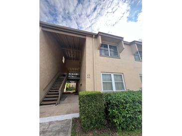Exterior view of condo building with stairs and landscaping at 458 Windmeadows St, Altamonte Springs, FL 32701