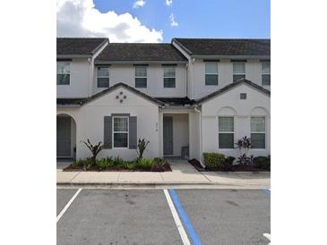 Modern townhome with gray siding, two-story design, and landscaping at 314 Captiva Dr, Davenport, FL 33896