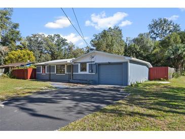 Newly painted house with a gray and white color scheme, a driveway, and a grassy lawn at 2084 Old New York Ave, Deland, FL 32720