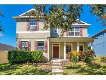 Two-story house with green siding, brown shutters, and a front porch at 2053 Nobscot Pl, Apopka, FL 32703