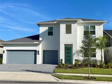 Two-story home with gray garage doors and teal front door at 58 Overleaf Ln, Orlando, FL 32839