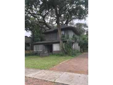 Two-story house exterior with brick driveway and large tree at 522 S Osceola Ave, Orlando, FL 32801