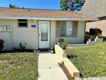 Single-story home with a walkway and small garden at 10301 Us Highway 27 # 85, Clermont, FL 34711