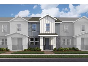 Modern two-story townhome with gray and brick facade at 159 Aulin Ave, Oviedo, FL 32765