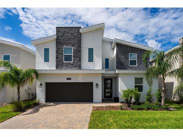 Modern two-story house with stone accents at 8896 Cabot Cliffs Dr, Davenport, FL 33896