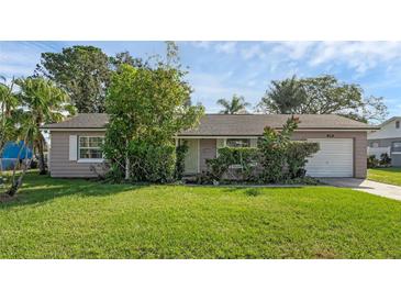 One-story home with a spacious lawn and attached garage at 2319 Continental Blvd, Orlando, FL 32808