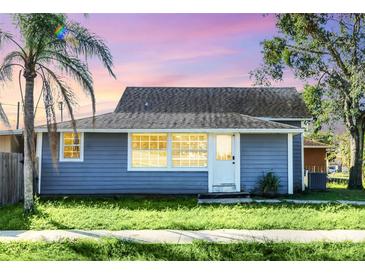 Quaint blue house with a front yard and landscaping at 1701 Minnesota Ave, Saint Cloud, FL 34769