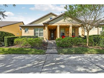 One-story home with yellow siding and a covered porch at 14132 Murcott Blossom Blvd, Winter Garden, FL 34787
