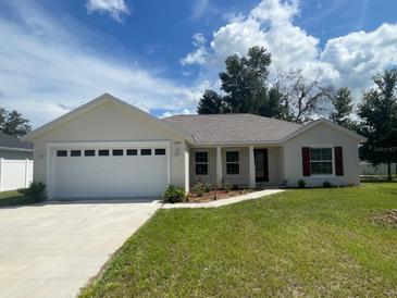 Two-car garage and front yard at 13394 Sw 106Th St, Dunnellon, FL 34432