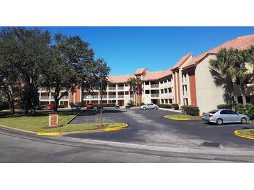 Two-story building with parking lot and landscaping at 6337 Parc Corniche Dr # 2106, Orlando, FL 32821