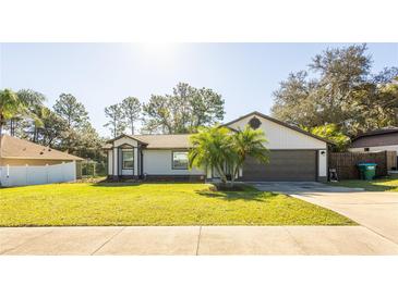 Charming ranch home with attached garage and manicured lawn at 796 Humphrey Cir, Deltona, FL 32738