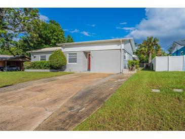 House exterior with a red door and a long driveway at 3121 Bon Air Dr, Orlando, FL 32818