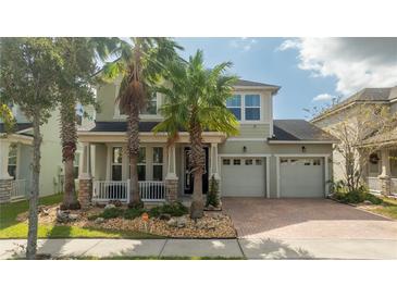 Two-story house with a three-car garage and palm trees at 4952 Creekside Park Ave, Orlando, FL 32811