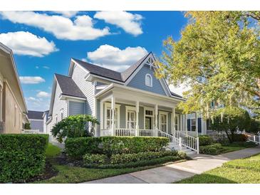 Charming two-story home with a front porch and manicured landscaping at 5374 Ardsdale Ln, Orlando, FL 32814