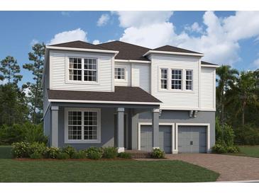 Two-story home with gray and white siding, three-car garage, and landscaping at 16869 Muskgrass Dr, Winter Garden, FL 34787