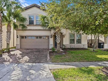 Two-story home with a large driveway and landscaped yard at 8832 Macapa Dr, Kissimmee, FL 34747