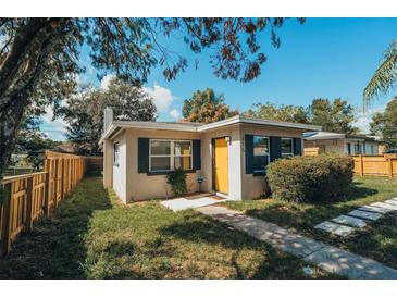 Charming bungalow with a yellow door and well-maintained landscaping at 315 E St, Lake Wales, FL 33853