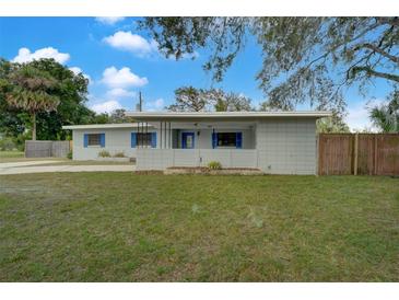 Updated ranch home with blue shutters and landscaped yard at 115 N Lakewood Cir, Maitland, FL 32751